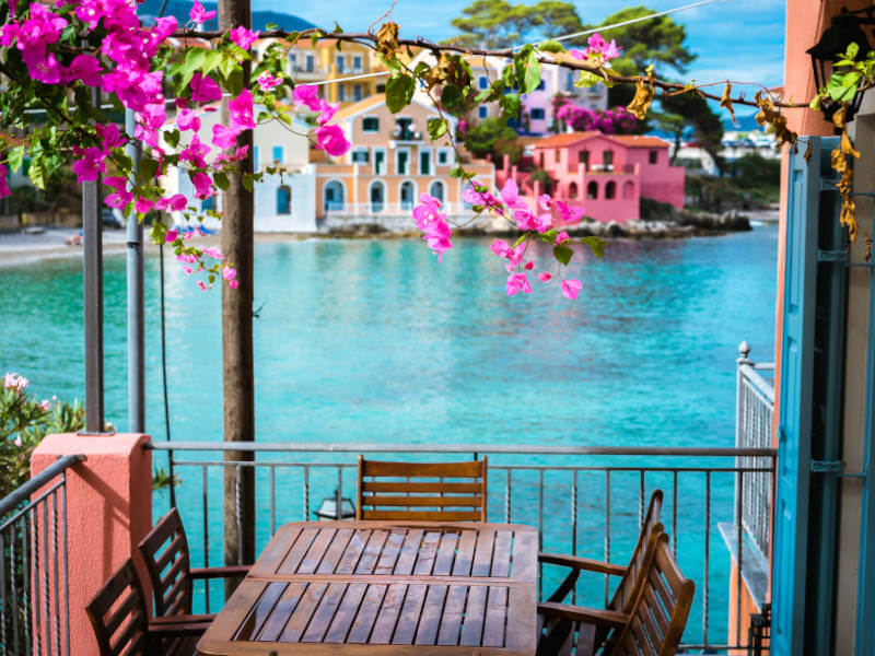 View of Lake from Hotel balcony  with pink flowers near the table and Chairs